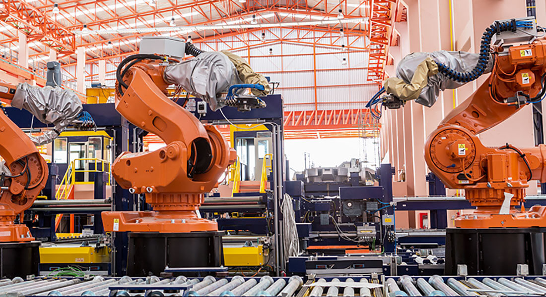Industrial welding robots in production line manufacturer factory